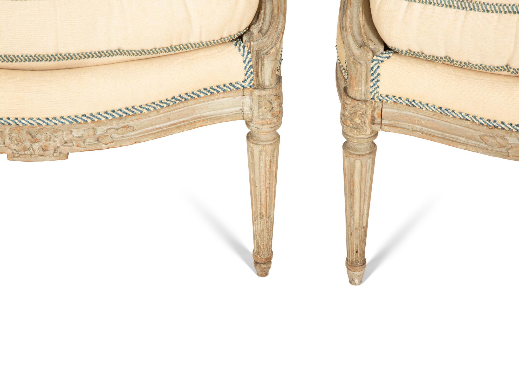 A Set of Four Louis XVI Grey-Painted and Parcel Gilt Fauteuils