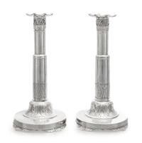 A Pair of Russian Silver Candlesticks, Maker's Mark Obscured, 1835, each set on a circular base bearing a monogram and coronet over fol