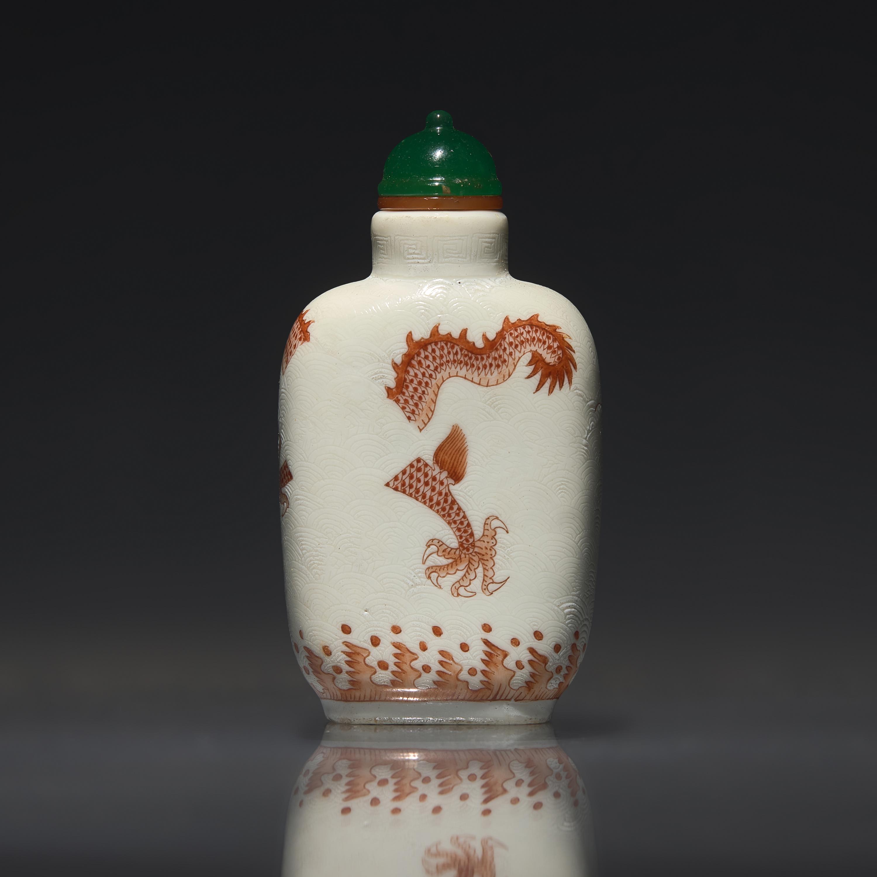 A Chinese Enameled Porcelain "Dragon" Snuff Bottle, Qing Dynasty, Daoguang Period — 清道光 瓷胎礬紅刻暗花龍紋鼻煙壺