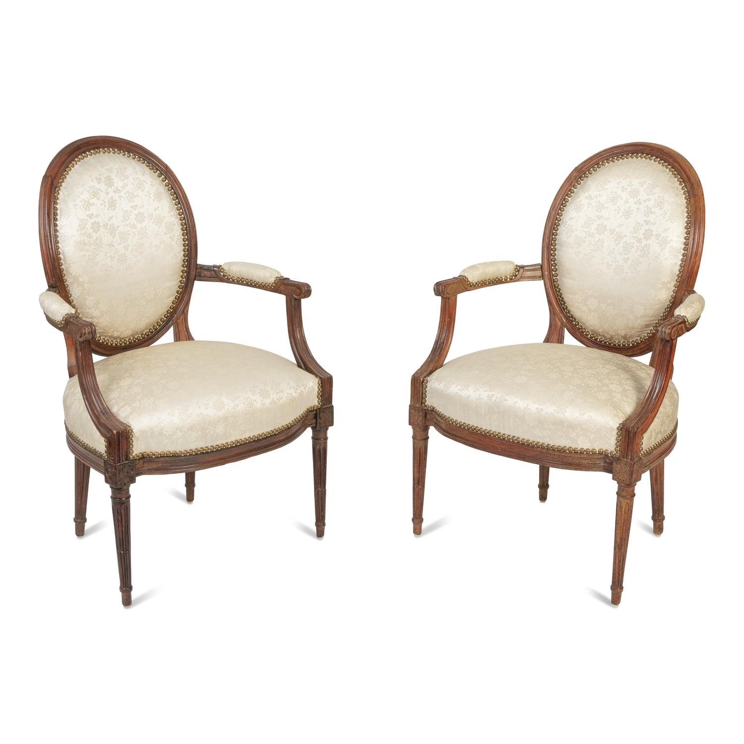 A Pair of Louis XVI Walnut Fauteuils en Cabriolet