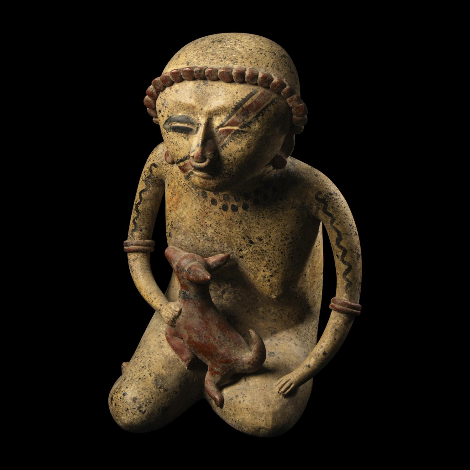 A Nayarit Terracotta Seated Figure with Dog