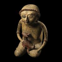 A Nayarit Terracotta Seated Figure with Dog