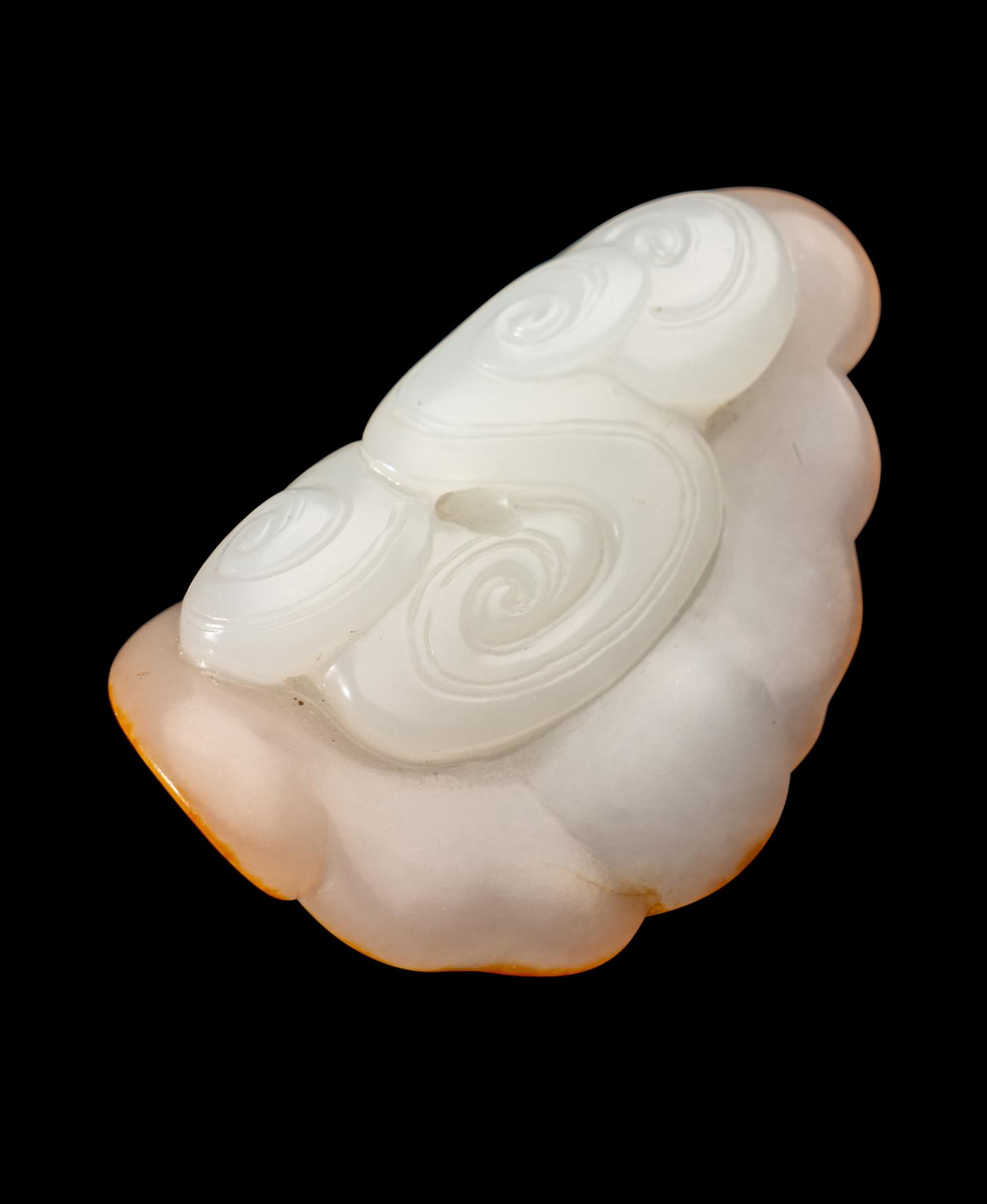 A Chinese Russet and White Jade Figure of a Bat