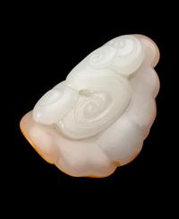 A Chinese Russet and White Jade Figure of a Bat