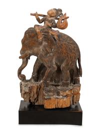 A Southeast Asian Carved and Painted Wood Group of an Elephant and Rider