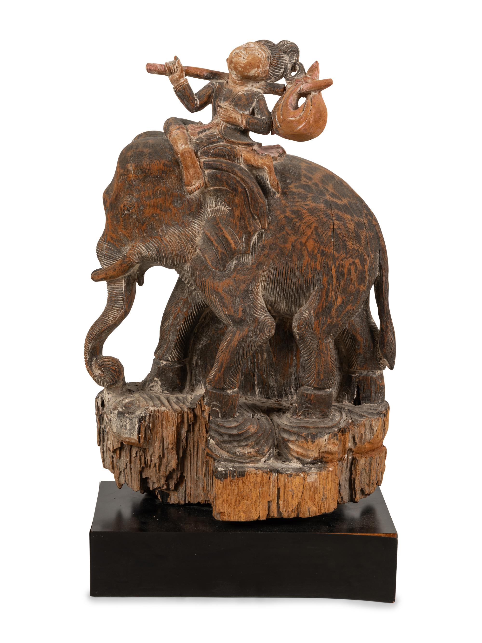 A Southeast Asian Carved and Painted Wood Group of an Elephant and Rider