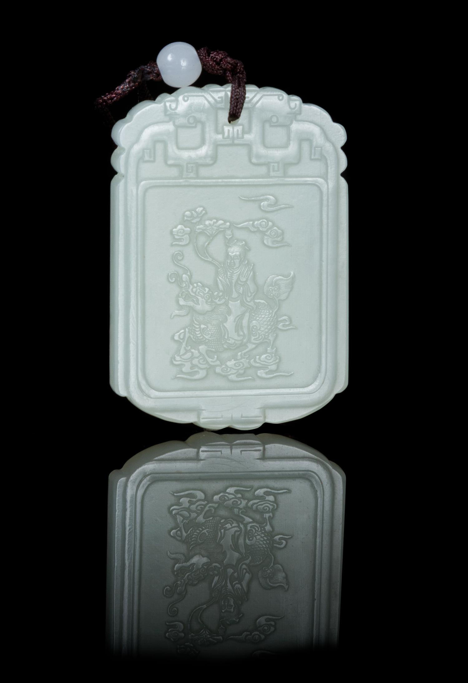 A Carved Pale Celadon Jade Plaque Height 1 7/8 inches.