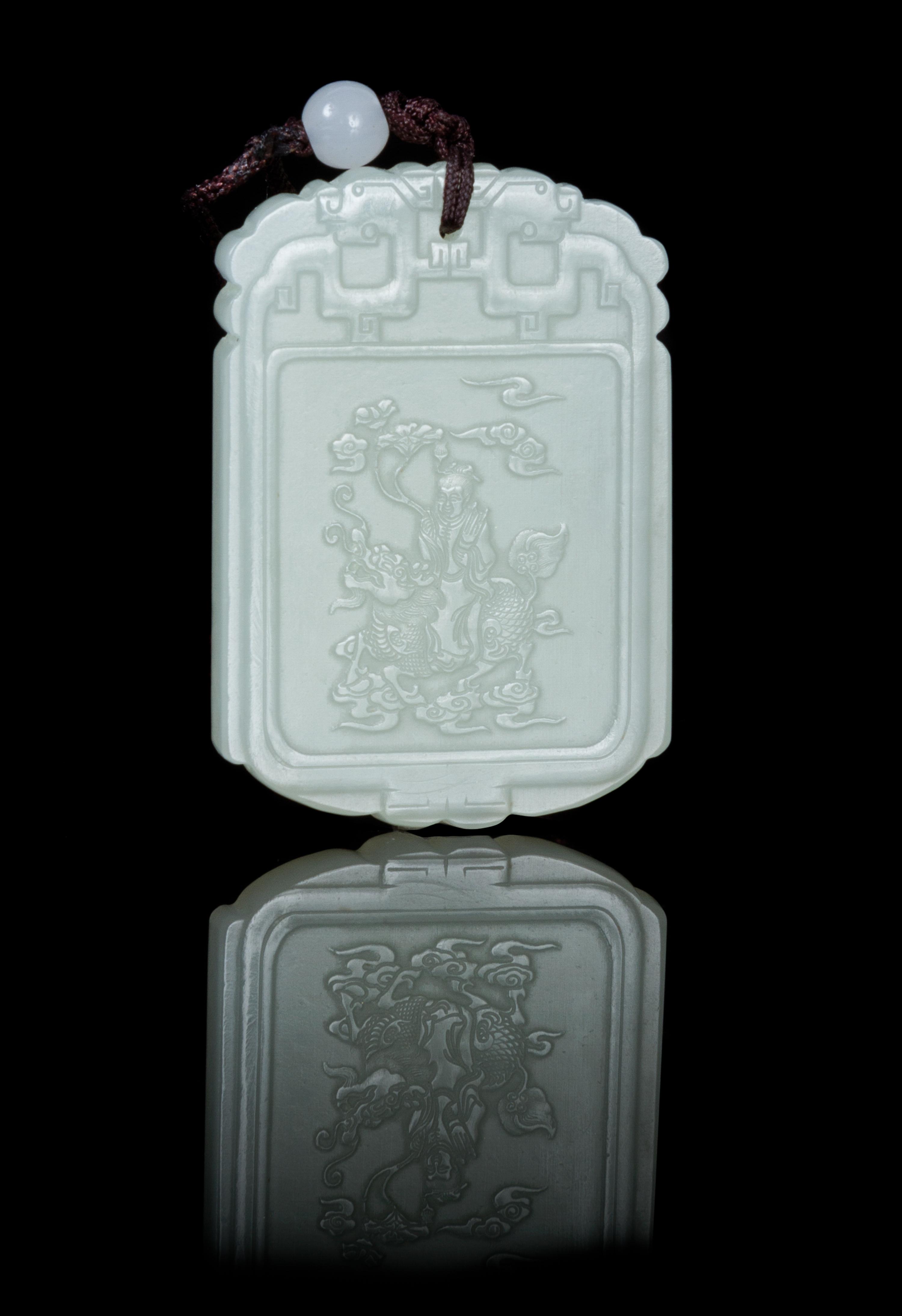 A Carved Pale Celadon Jade Plaque Height 1 7/8 inches.