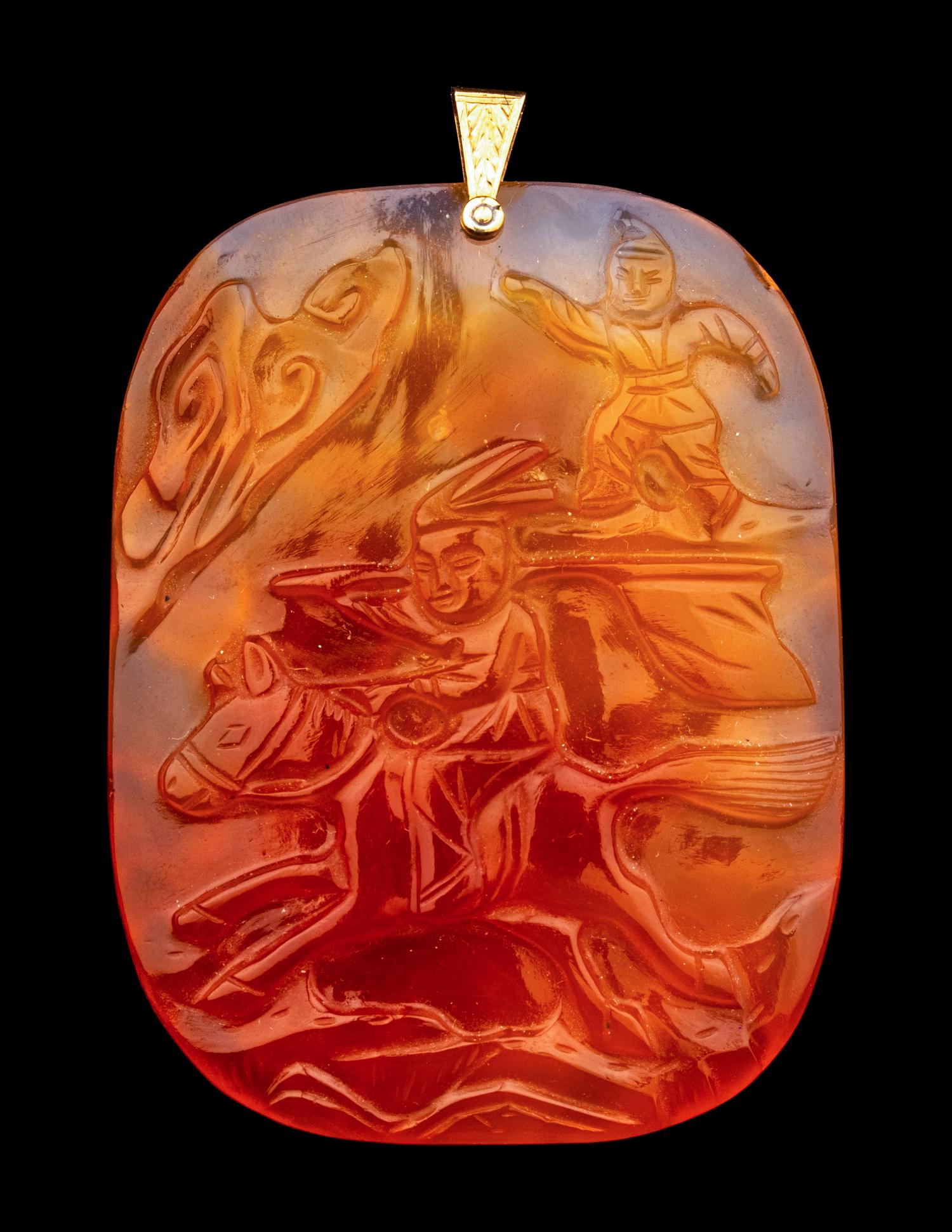 A Group of Chinese Red Carnelian and Coral Pendants