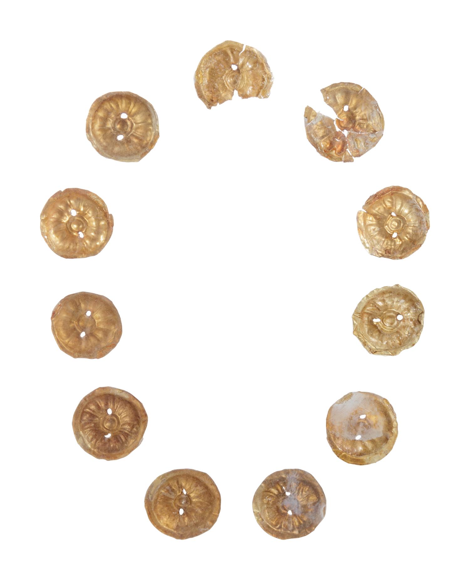 Eleven Gilt Metal or Gold Buttons on an Acrylic Stand