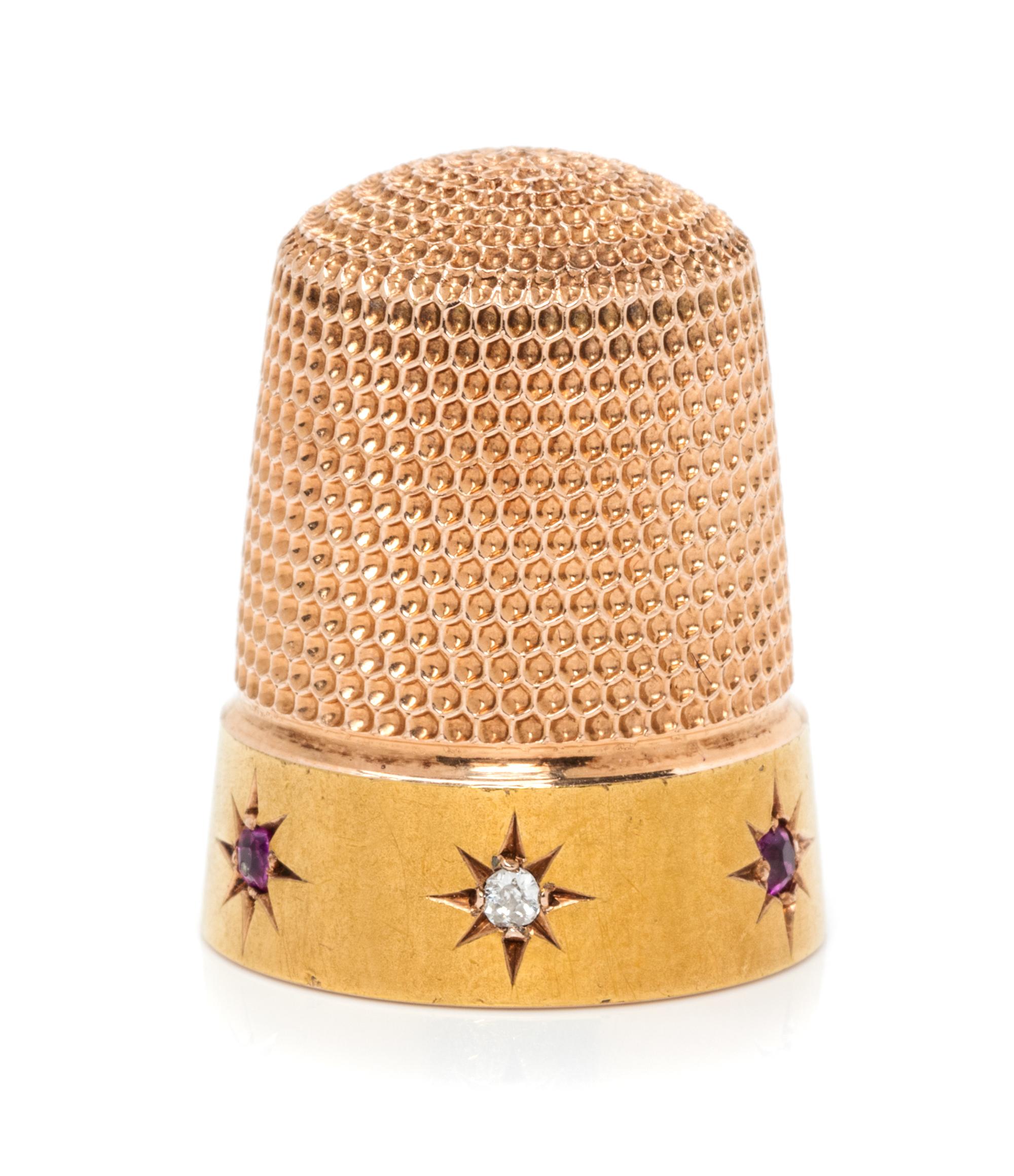 An American 14-Karat Yellow Gold, Diamond and Ruby Thimble, Simons Brothers Co., Philadelphia, PA, the knurled top and body above a pla