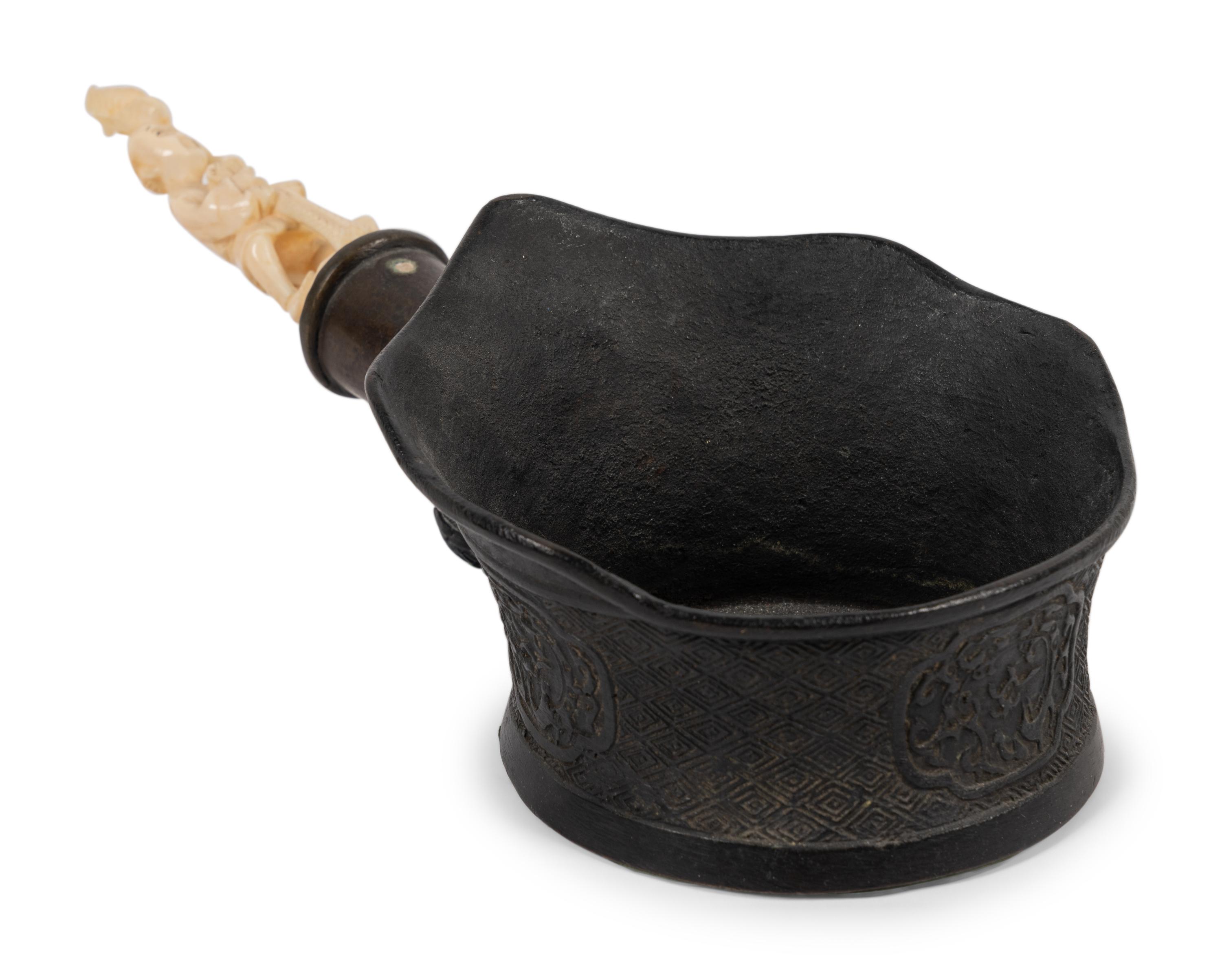 A Chinese Silk Iron with a Figural Handle