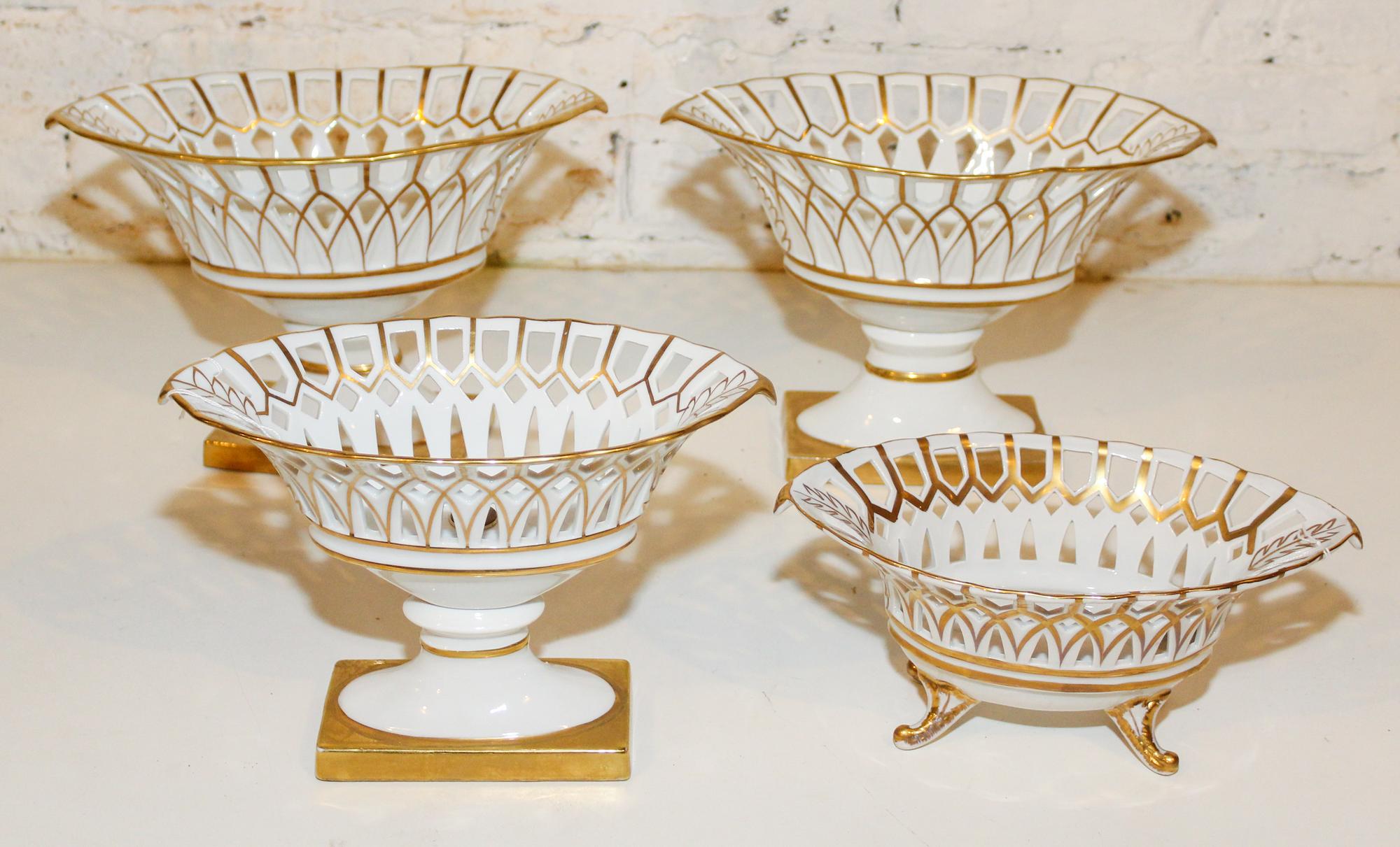 A Collection of Four Gilt Painted Porcelain Baskets Height of pair 8 1/4 x width 12 inches.