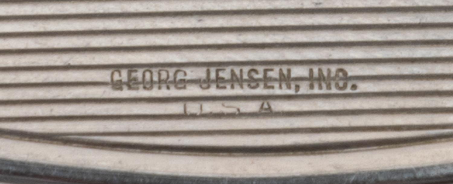 An American Silver Compact, Georg Jensen Inc., New York, NY, Circa 1940, or oval form, the lid with an engraved name and applied foliat