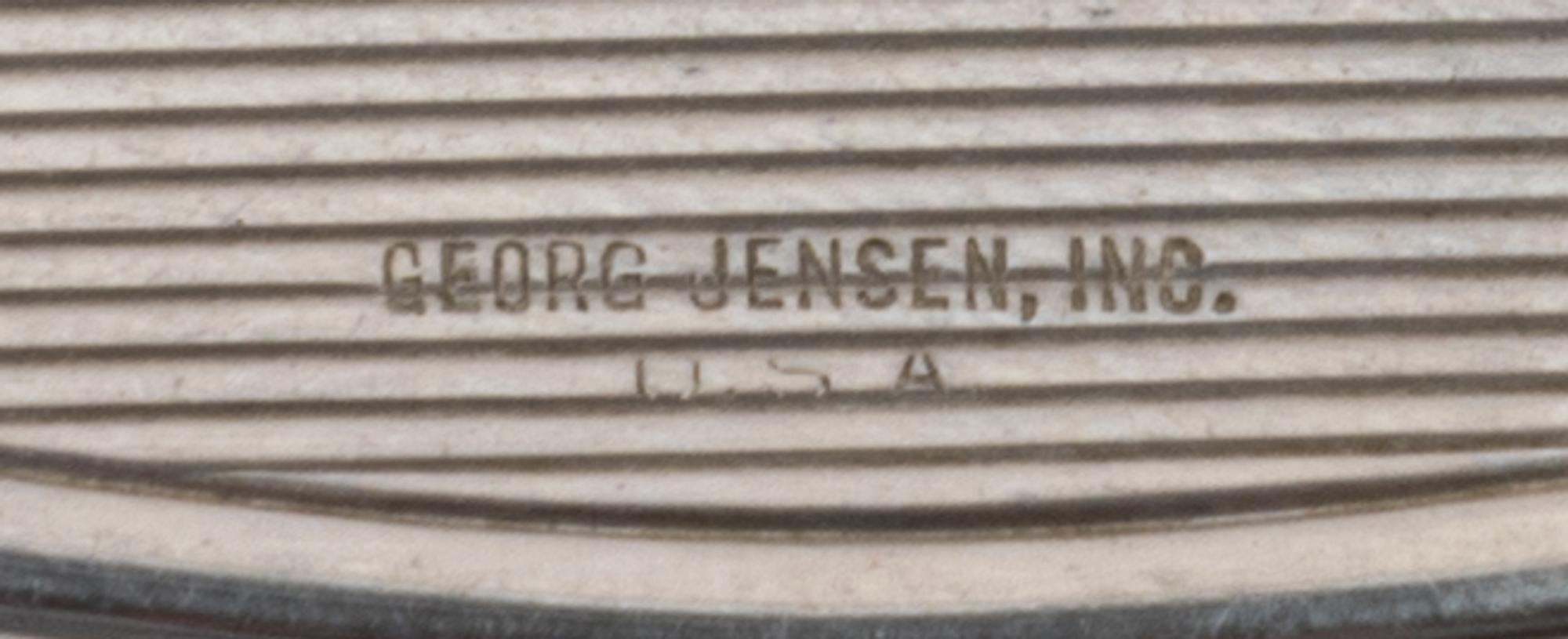 An American Silver Compact, Georg Jensen Inc., New York, NY, Circa 1940, or oval form, the lid with an engraved name and applied foliat