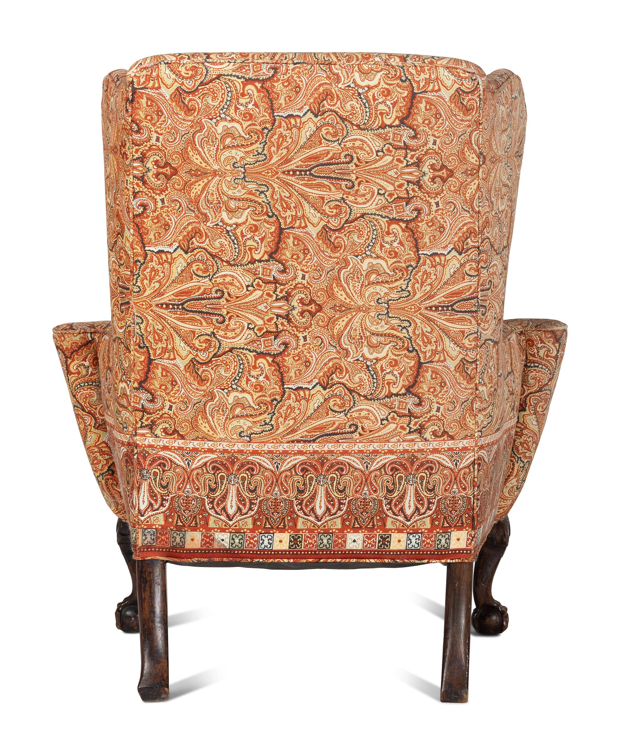A George III Carved Walnut Claw-and-Ball Foot Easy Chair