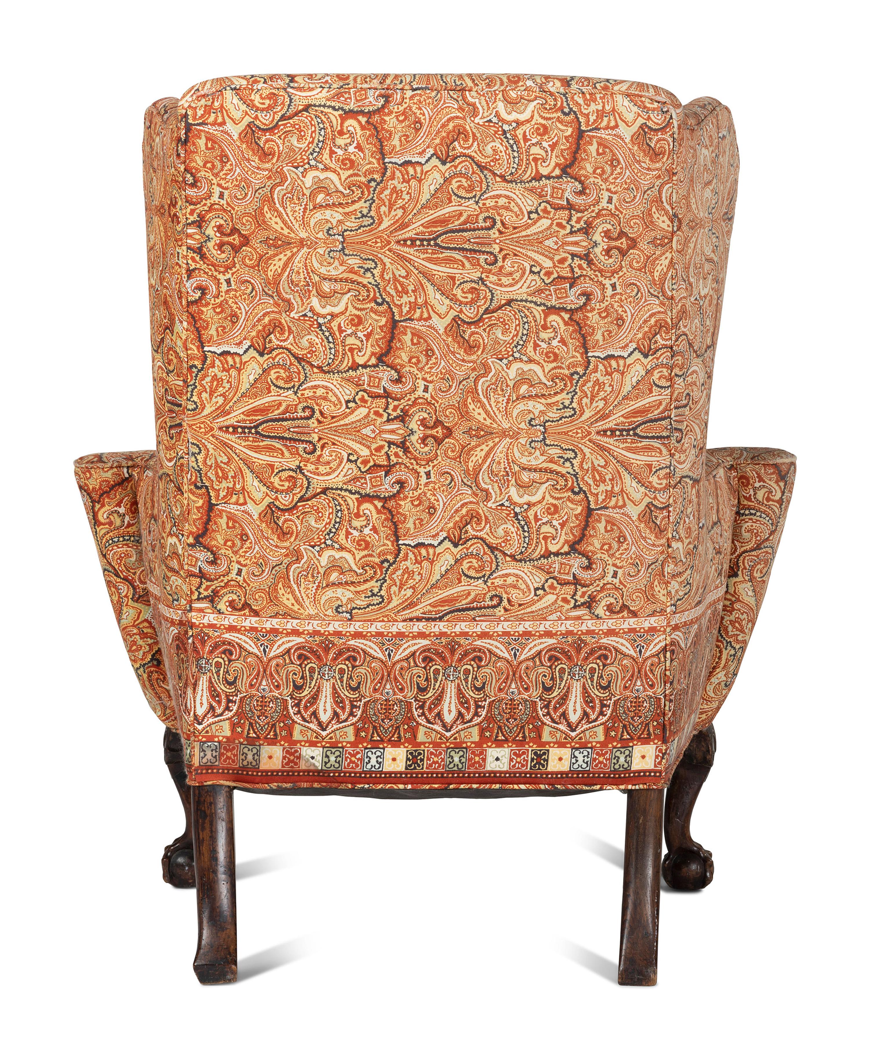 A George III Carved Walnut Claw-and-Ball Foot Easy Chair