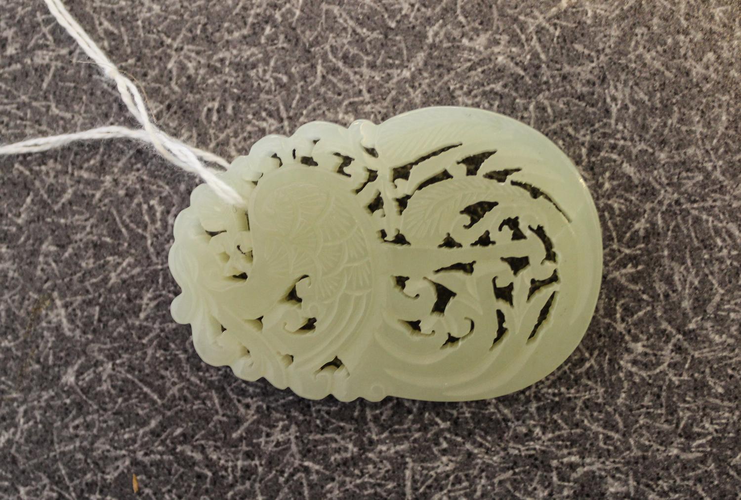 A Celadon Jade Pendant. Length 2 1/4 inches.