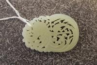A Celadon Jade Pendant. Length 2 1/4 inches.