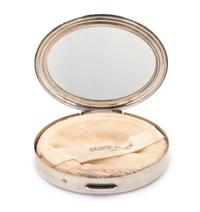 An American Silver Compact, Georg Jensen Inc., New York, NY, Circa 1940, or oval form, the lid with an engraved name and applied foliat
