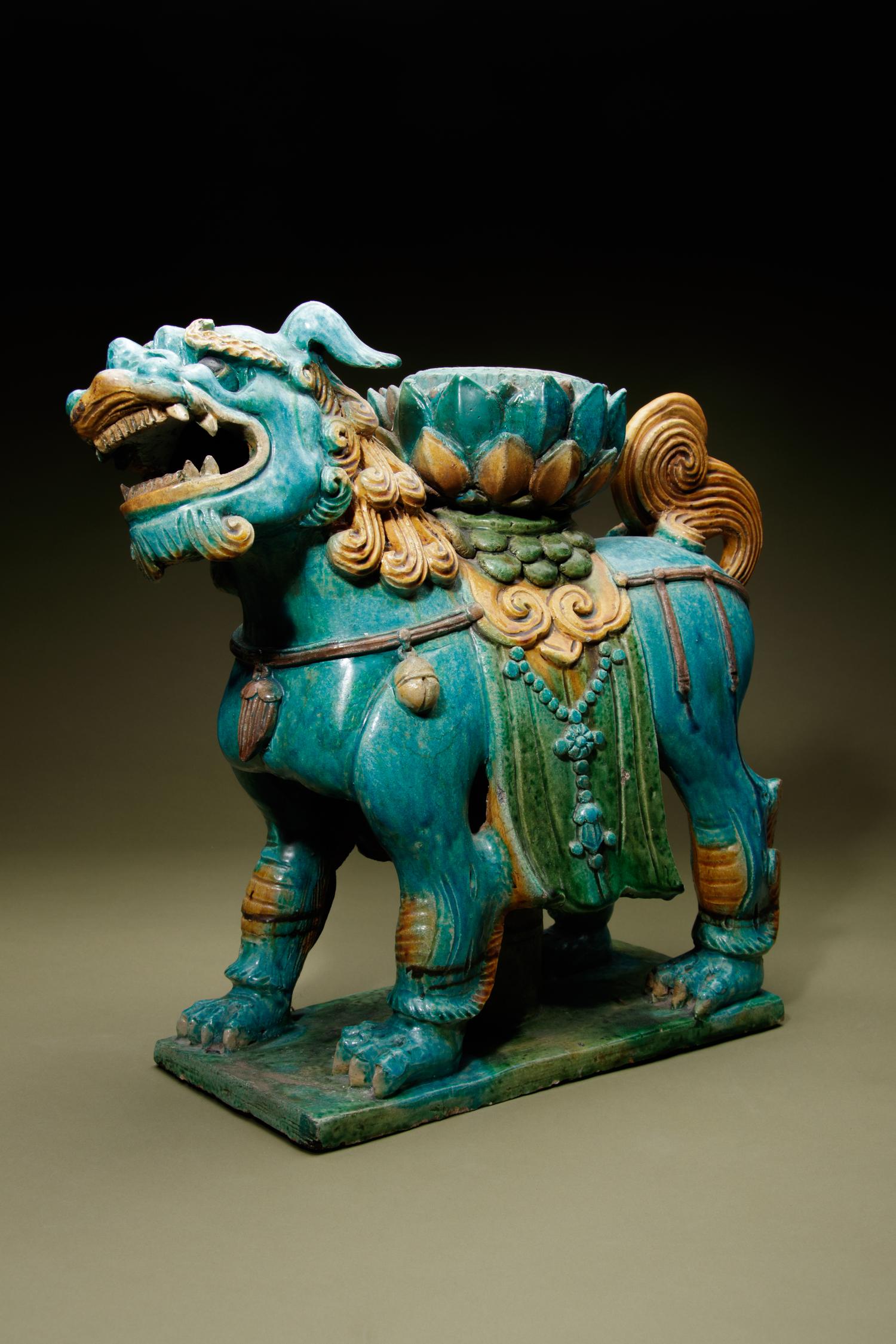 A Turquoise, Ochre and Green Glazed Tileworks 'Fu Lion' Stand