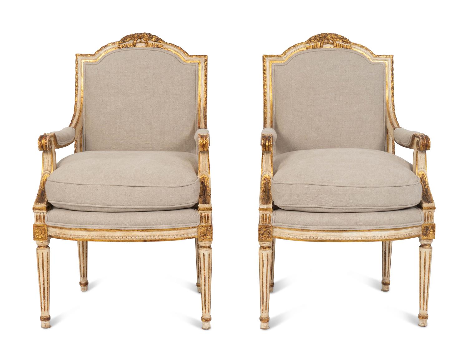 A Pair of Louis XVI Style Painted and Parcel Gilt Fauteuils — EARLY 20TH CENTURY