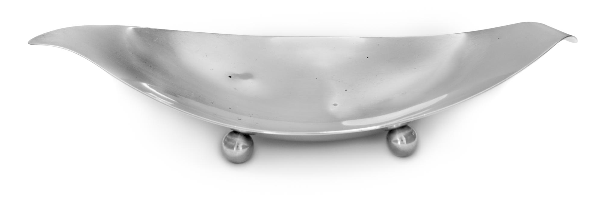 An American Silver Dish, Tiffany & Co., New York, NY, of oval form with flared edges and raised on four ball feet.