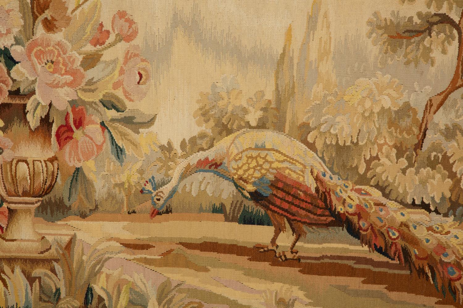 A Framed Needlework Panel Depicting a Peacock in Landscape