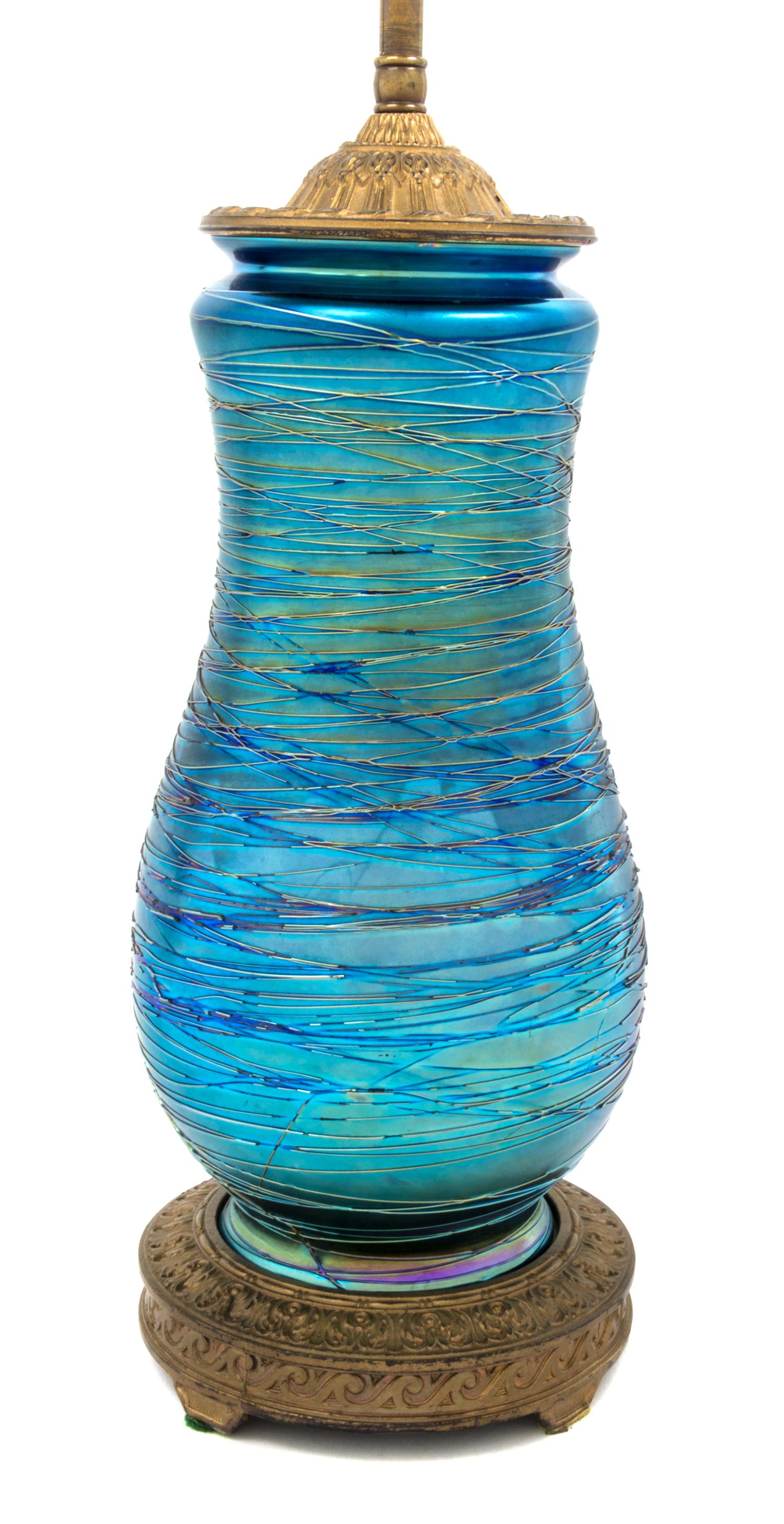 Durand, EARLY 20TH CENTURY, a glass table lamp, of baluster form with threaded decoration