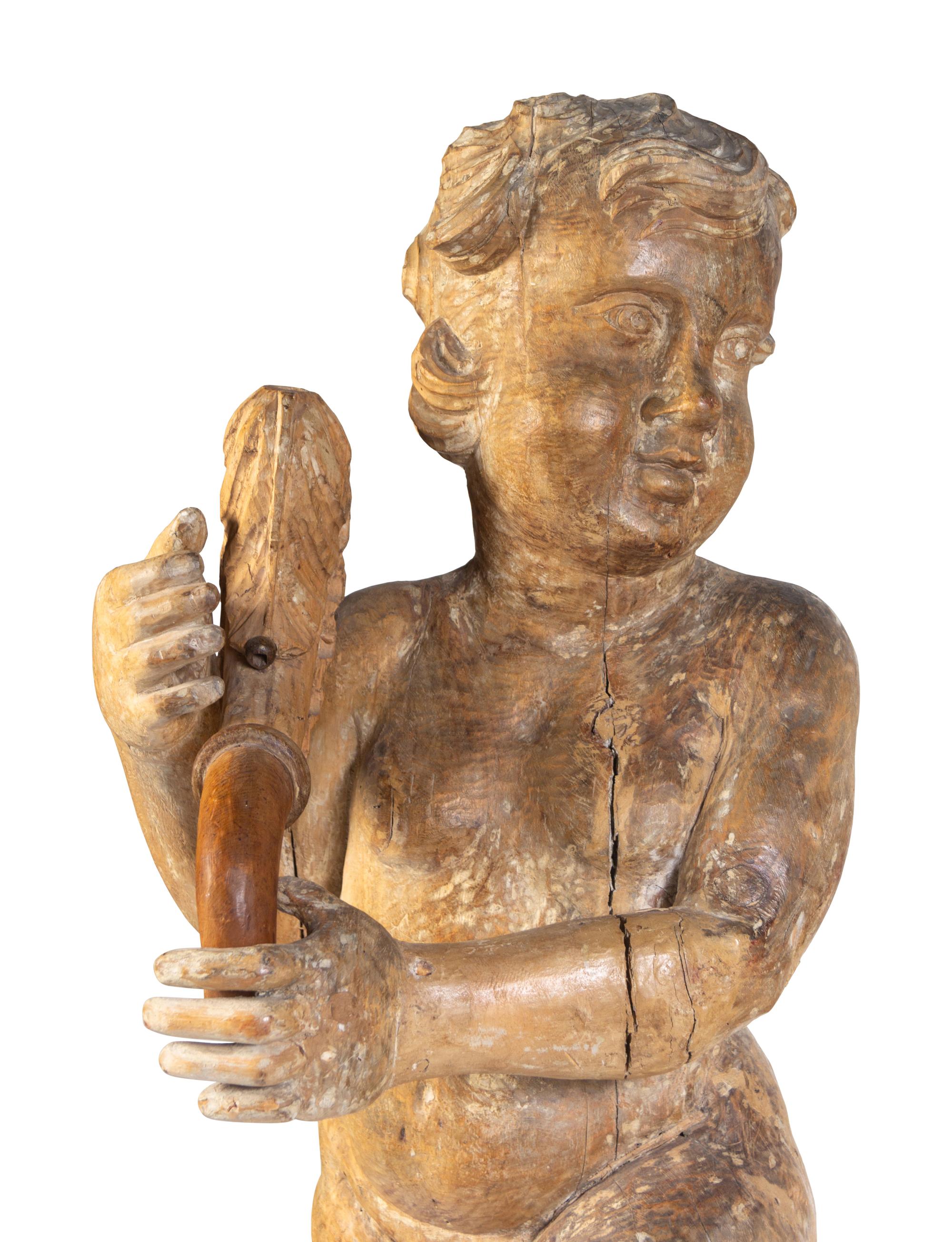 A Pair of Florentine Carved Walnut Figures of Putti on Plinths