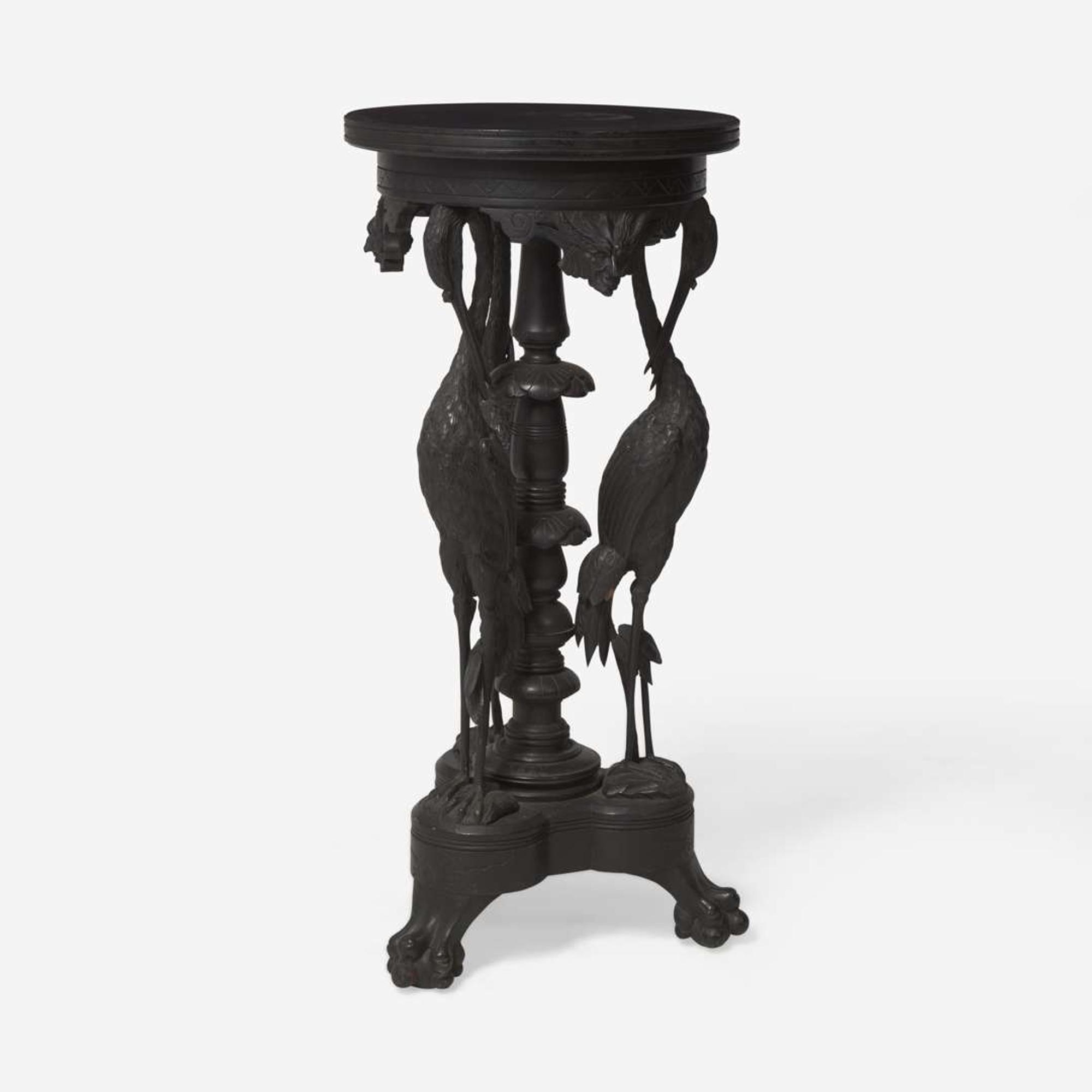 An Aesthetic Movement carved and ebonized wood pedestal with cranes late 19th century