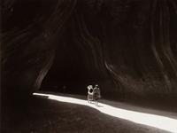A group of four photographs ( O'Keeffe, Glen Canyon , 1961 (printed 1984); Georgia O'Keeffe Photographing the Chama River , 1961 (printed 1984); Untitled (O'Keeffe walking towards building) , 1960s; Untitled (O'Keeffe walking from building ), 1959 (printed 1984))