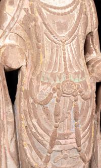 A Chinese Carved Sandstone Buddha with Remnants of Polychrome Decoration