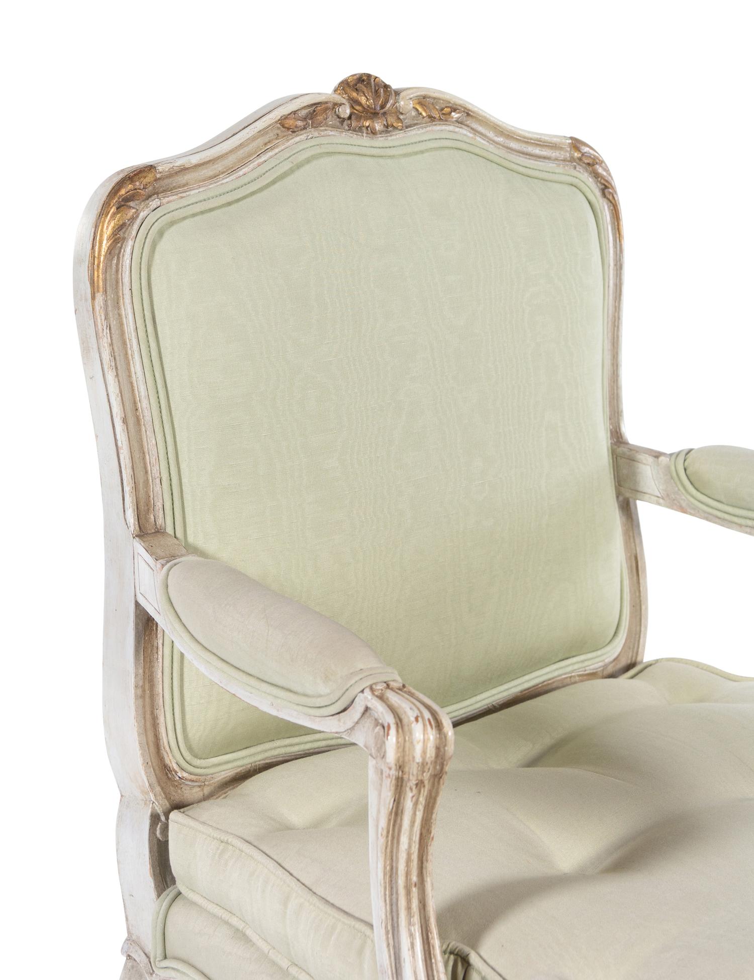 A Set of Twelve Louis XV Style Painted and Parcel Gilt Dining Chairs