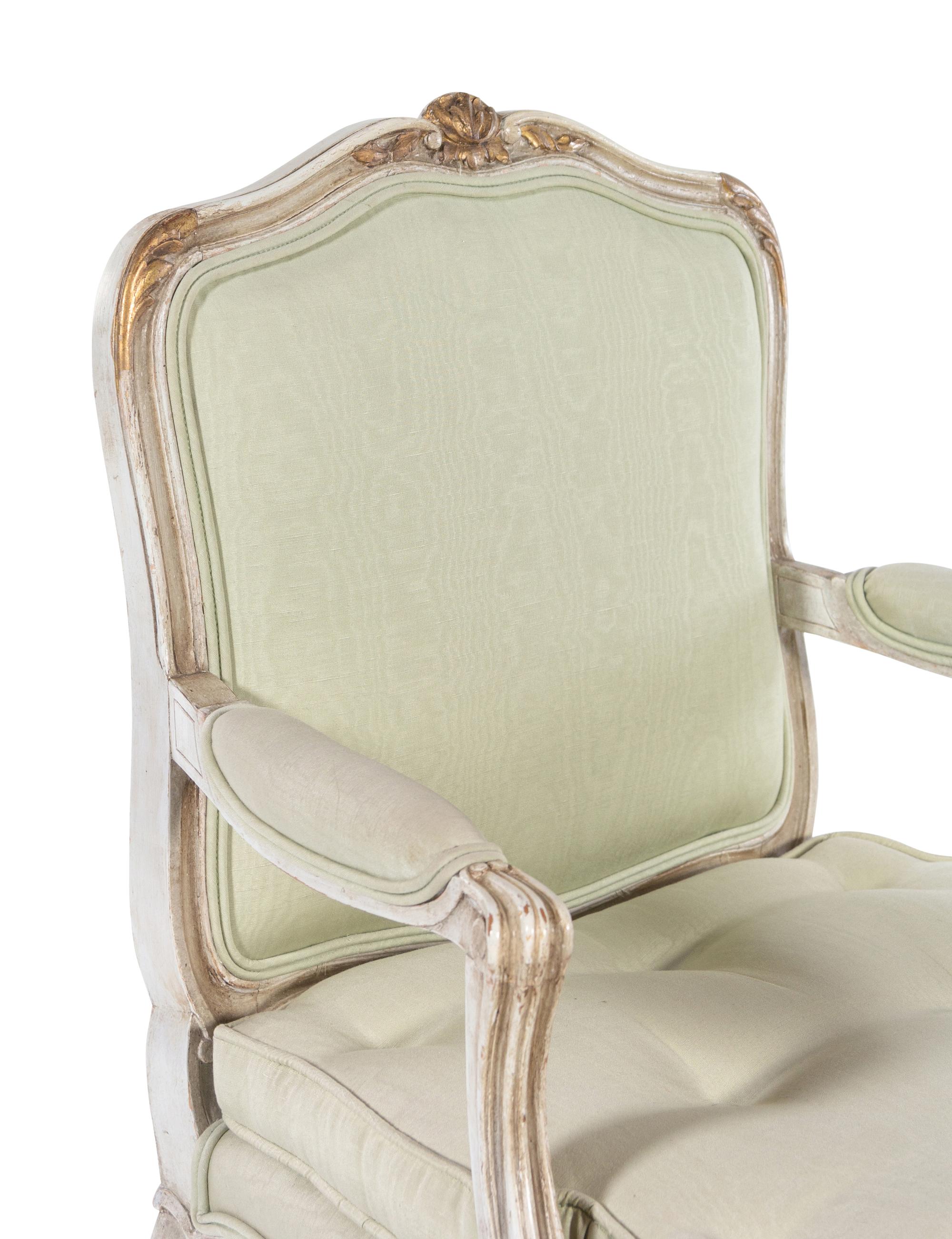 A Set of Twelve Louis XV Style Painted and Parcel Gilt Dining Chairs