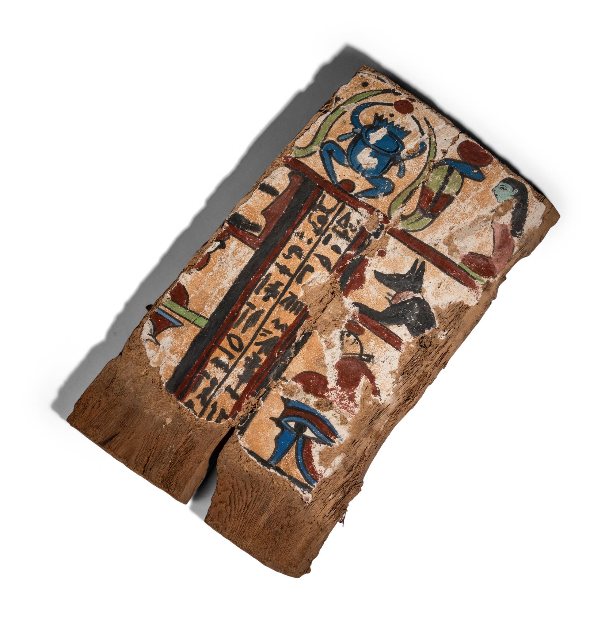 An Egyptian Painted Wood Sarcophagus Fragment with a Scarab