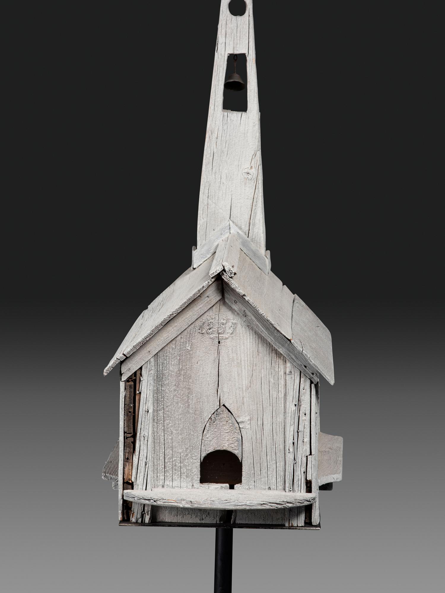 A Carved Wood Church Form Bird House on Stand