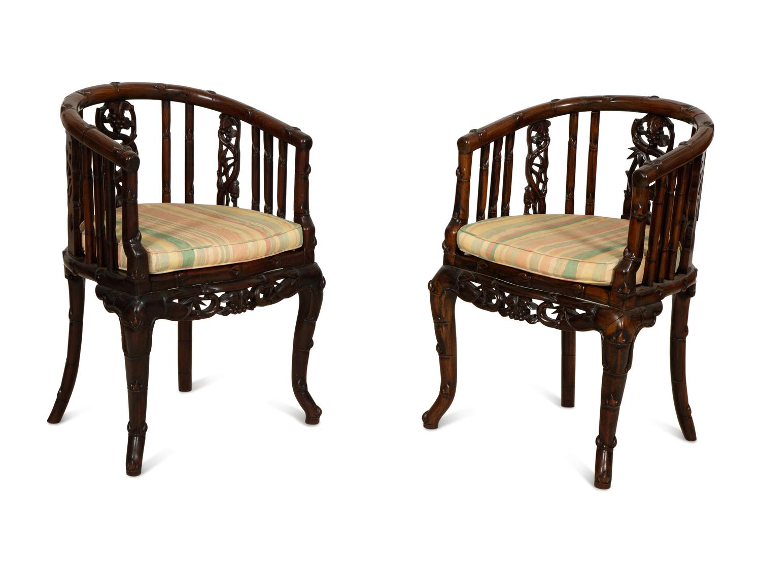 A Pair of Chinese Hongmu Horseshoe Back Carved Armchairs