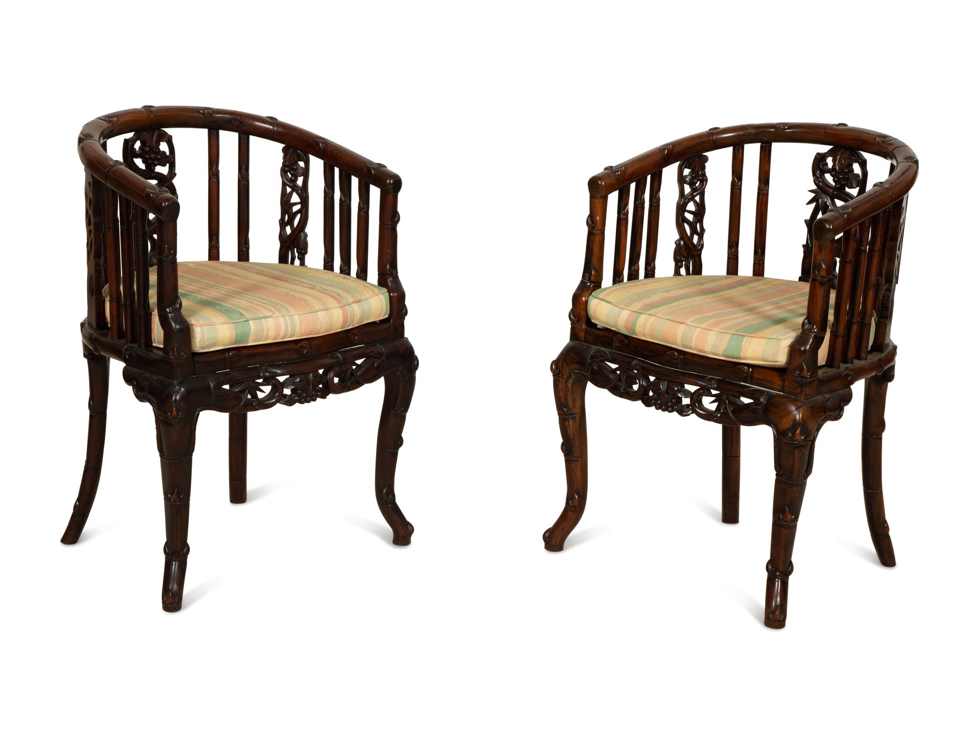 A Pair of Chinese Hongmu Horseshoe Back Carved Armchairs