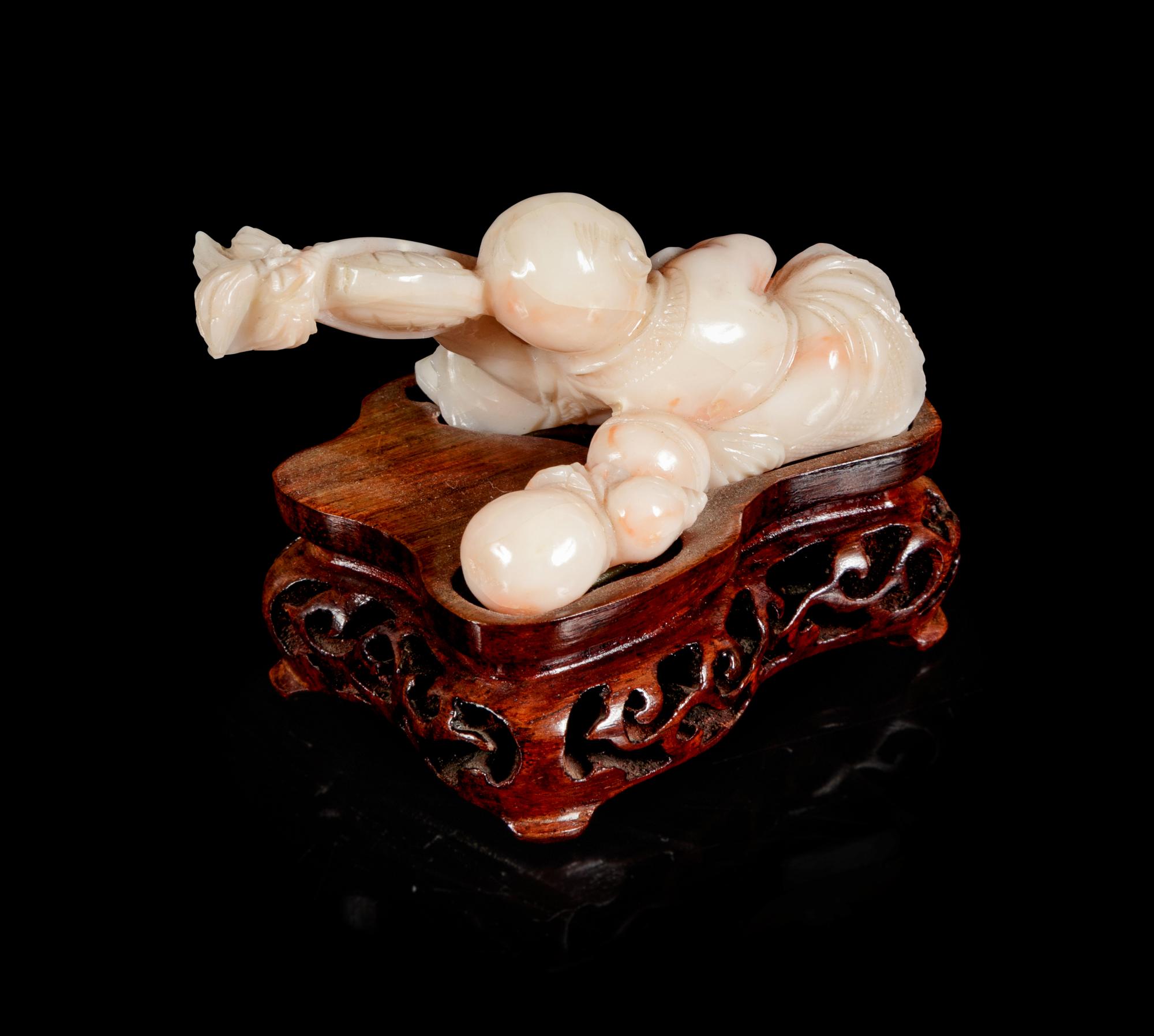 A Pink Coral Carving of a Boy
