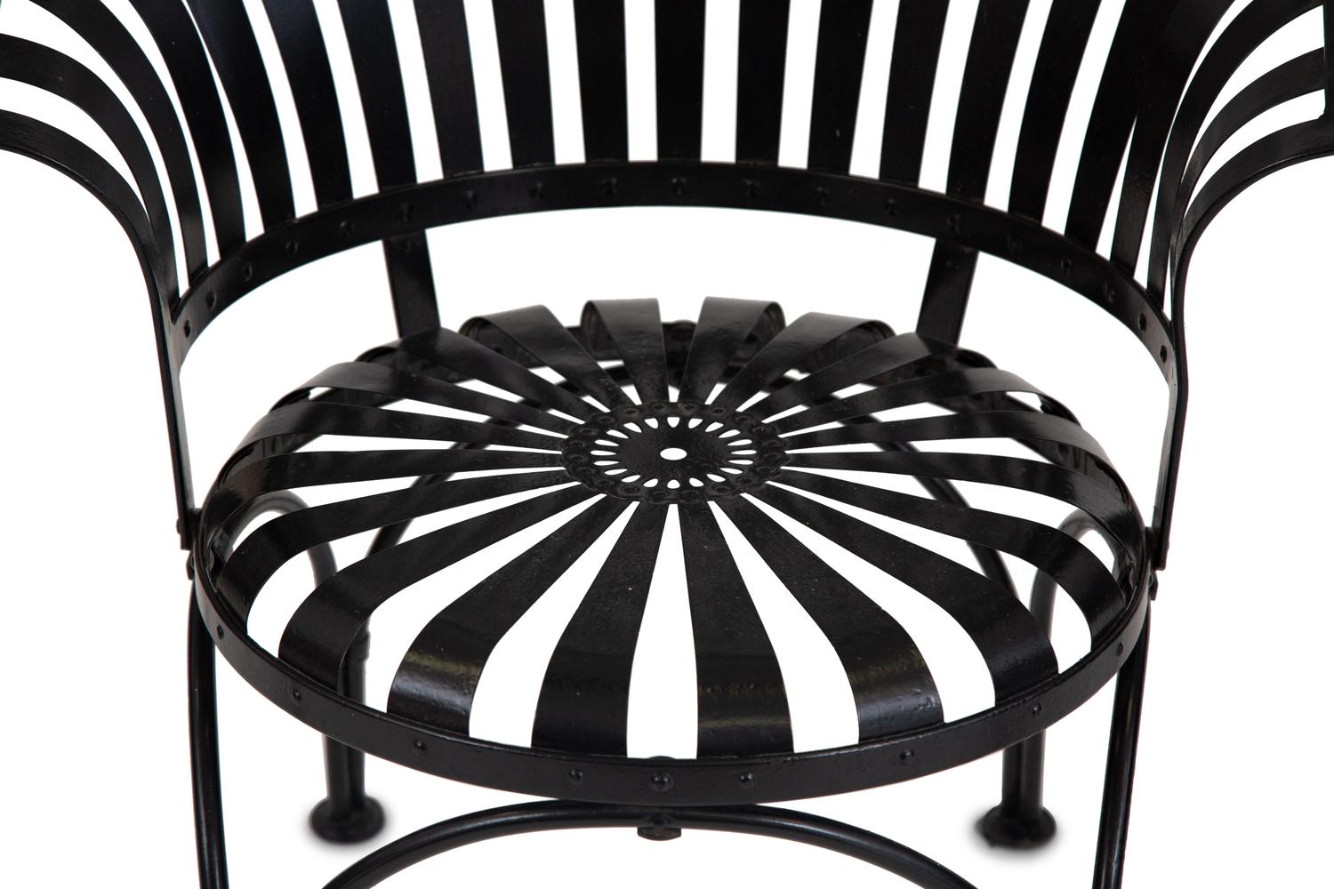 A Spring Steel Garden Table and Eight Chairs by Francois Carre