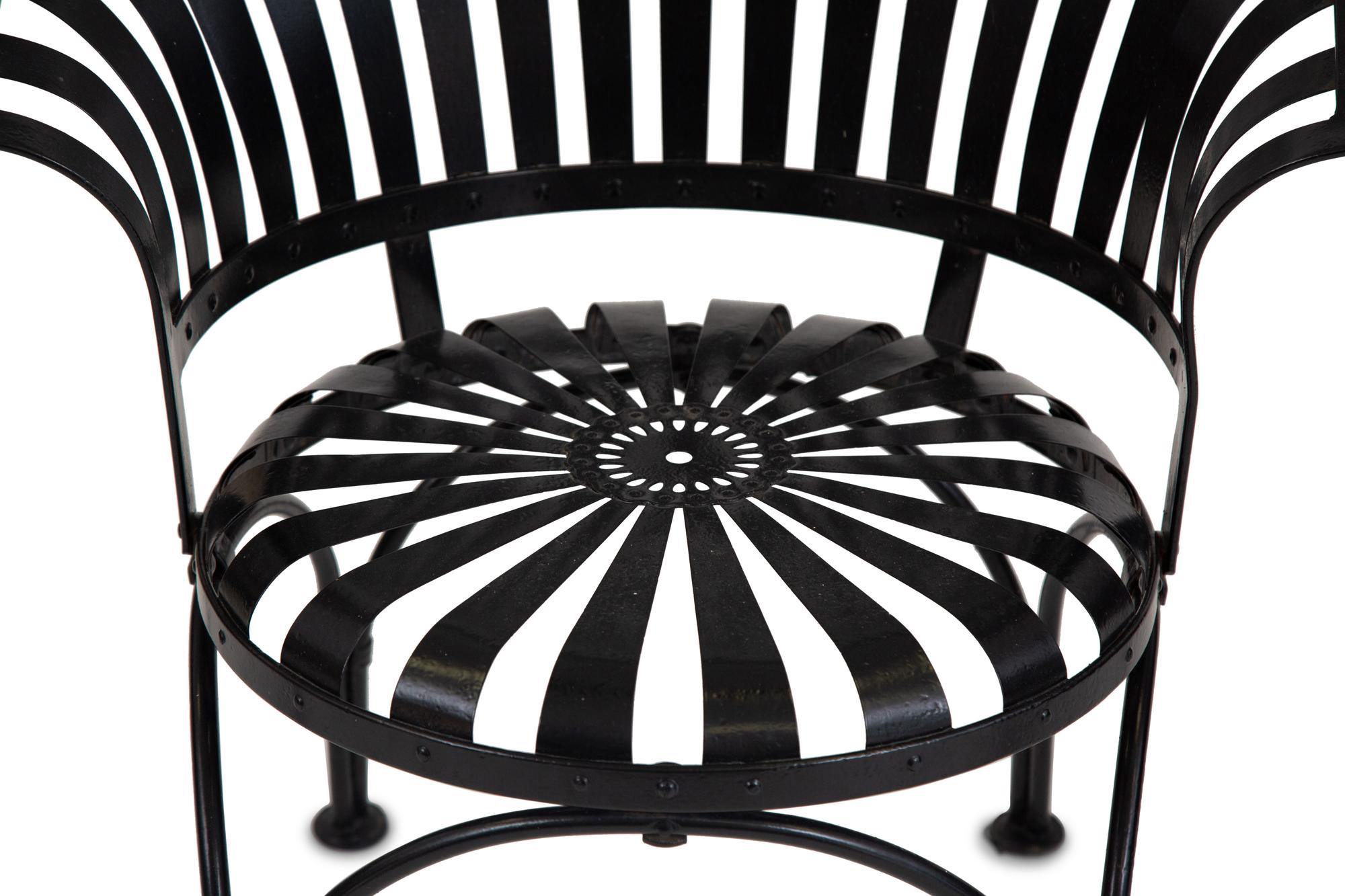 A Spring Steel Garden Table and Eight Chairs by Francois Carre