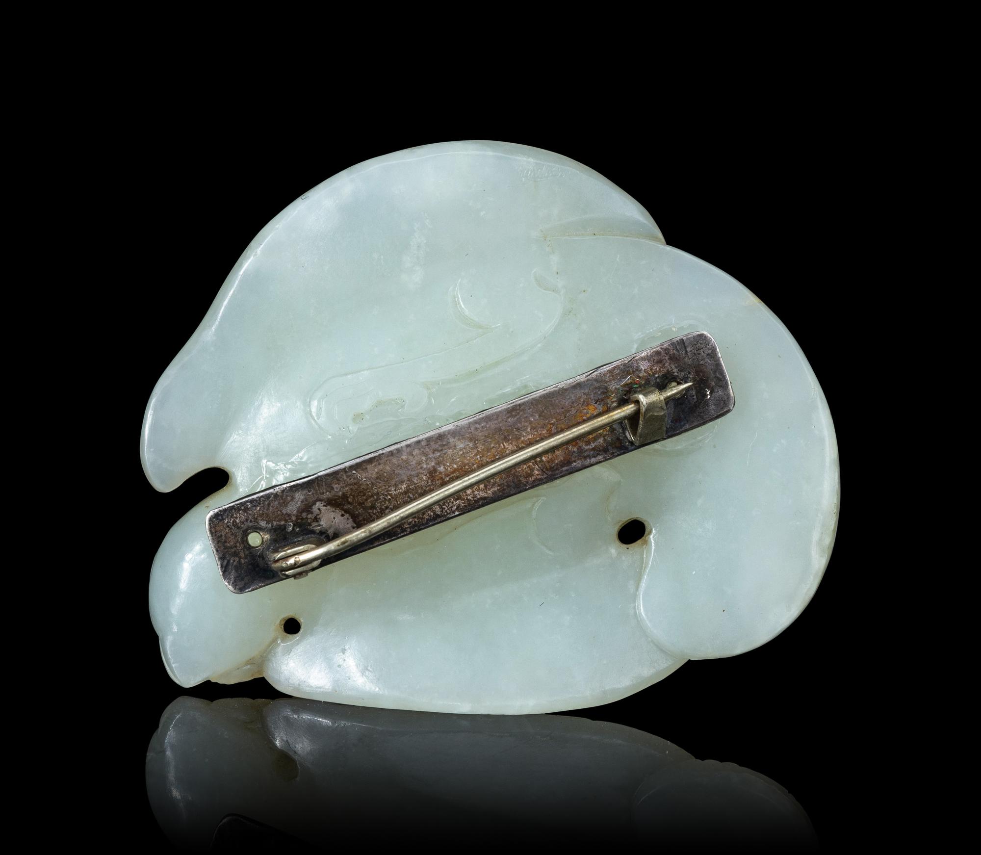 A Carved White Jade Figure of a Parrot