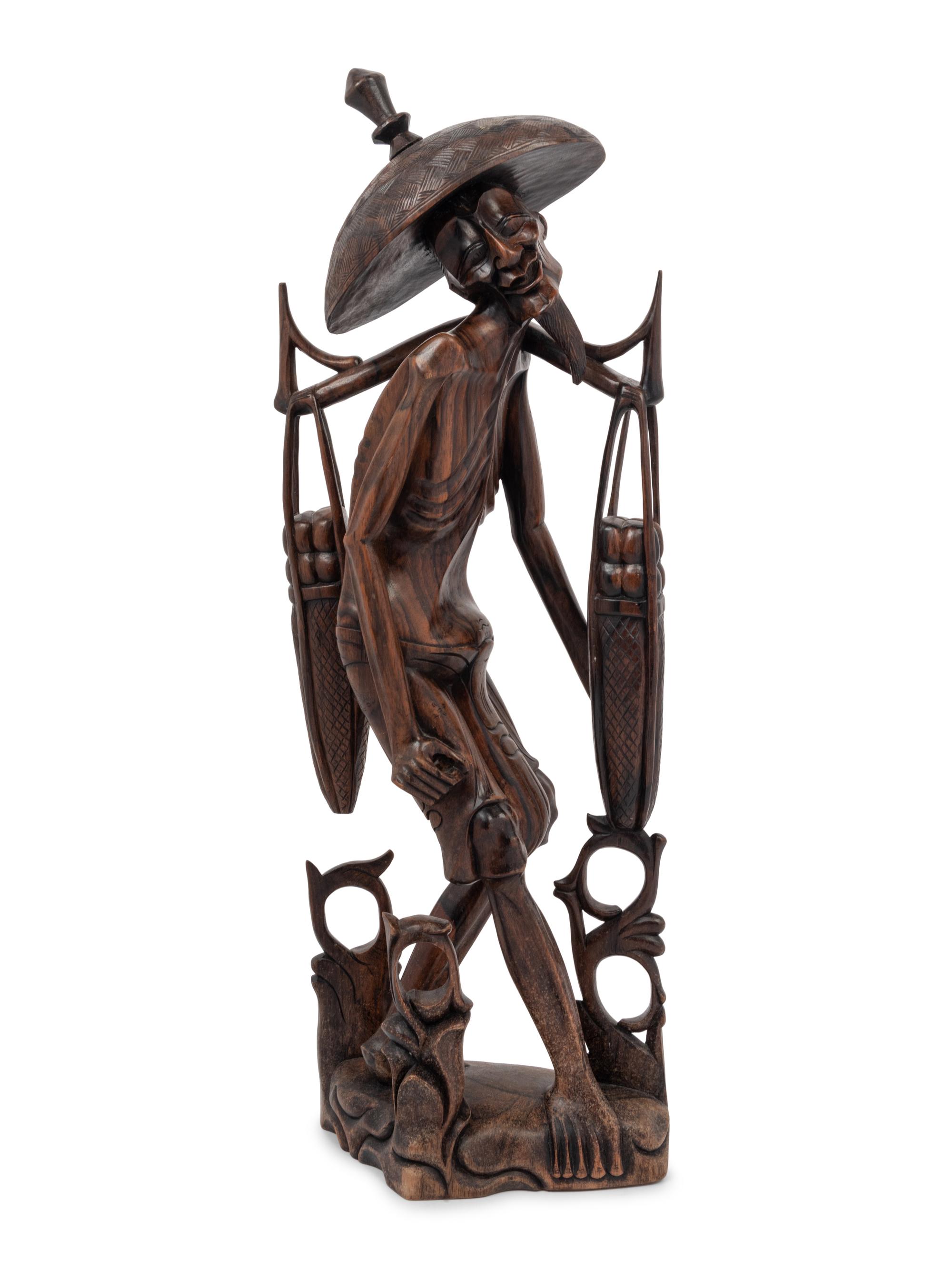 A Carved Wood Figure of a Water Carrier