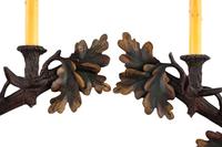 A Pair of Black-Forest Style Polychrome Decorated Two-Light Sconces