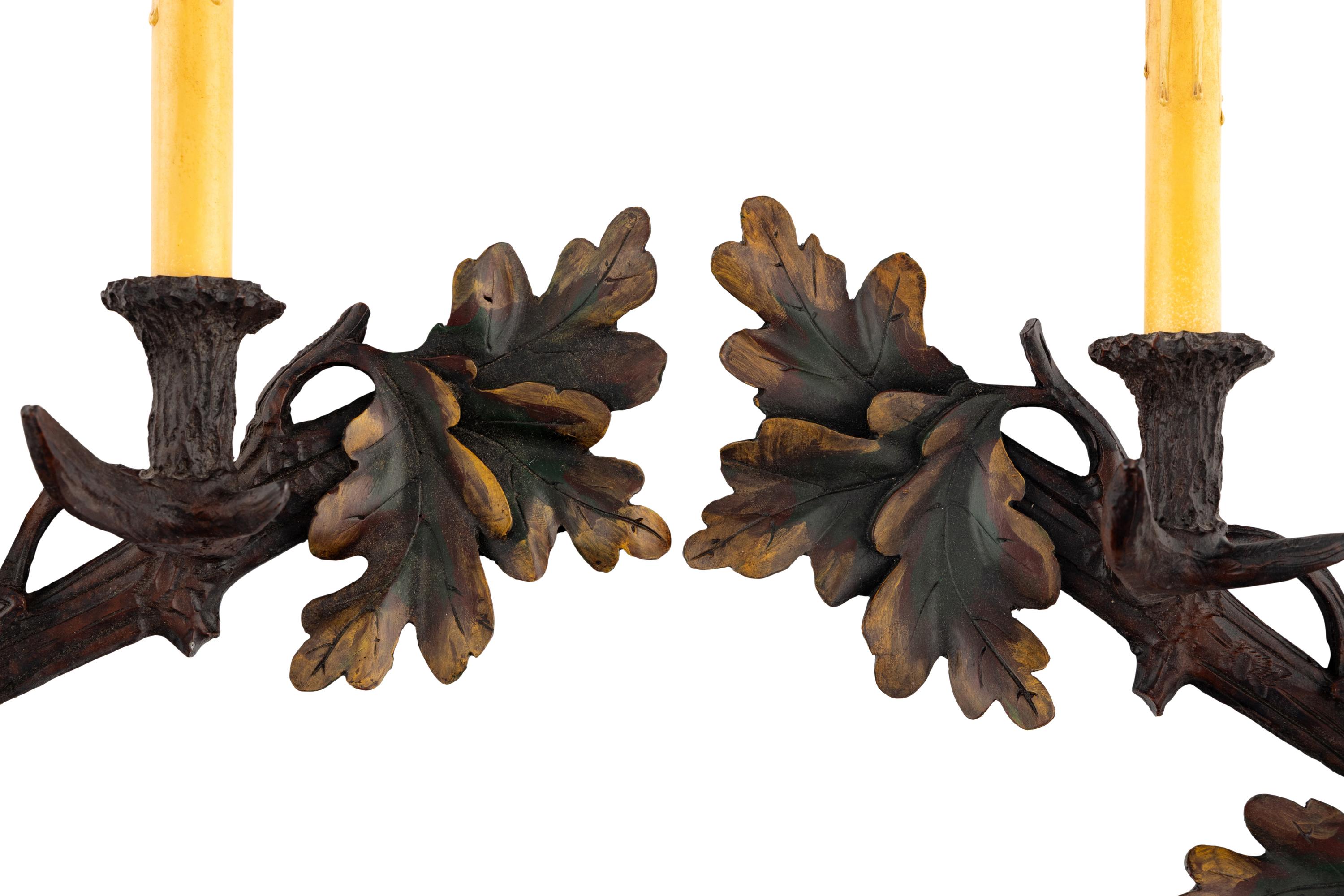 A Pair of Black-Forest Style Polychrome Decorated Two-Light Sconces