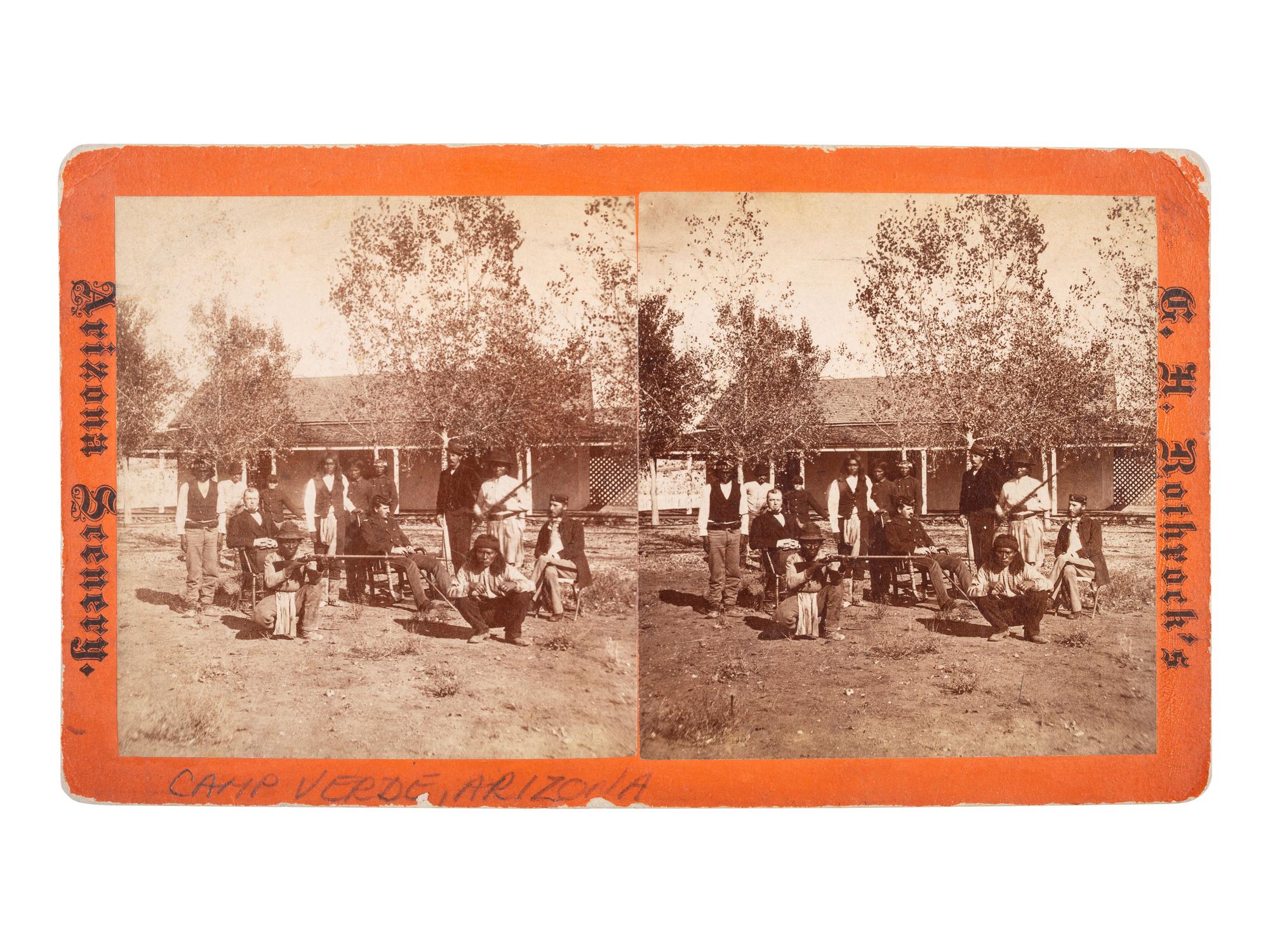 [NATIVE AMERICANS]. ROTHROCK, G.H. (1843-1924), photographer. Stereoview of Apache scouts and officers in front of quarters, Camp Verde. [Phoenix, AZ].