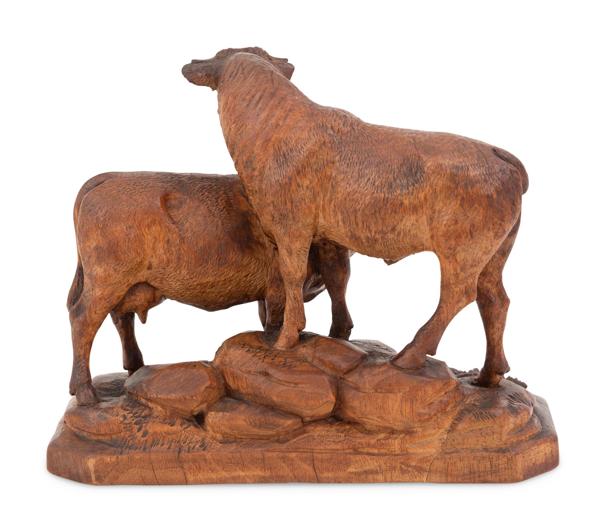 A Swiss Black Forest Carved Bull and Cow Group