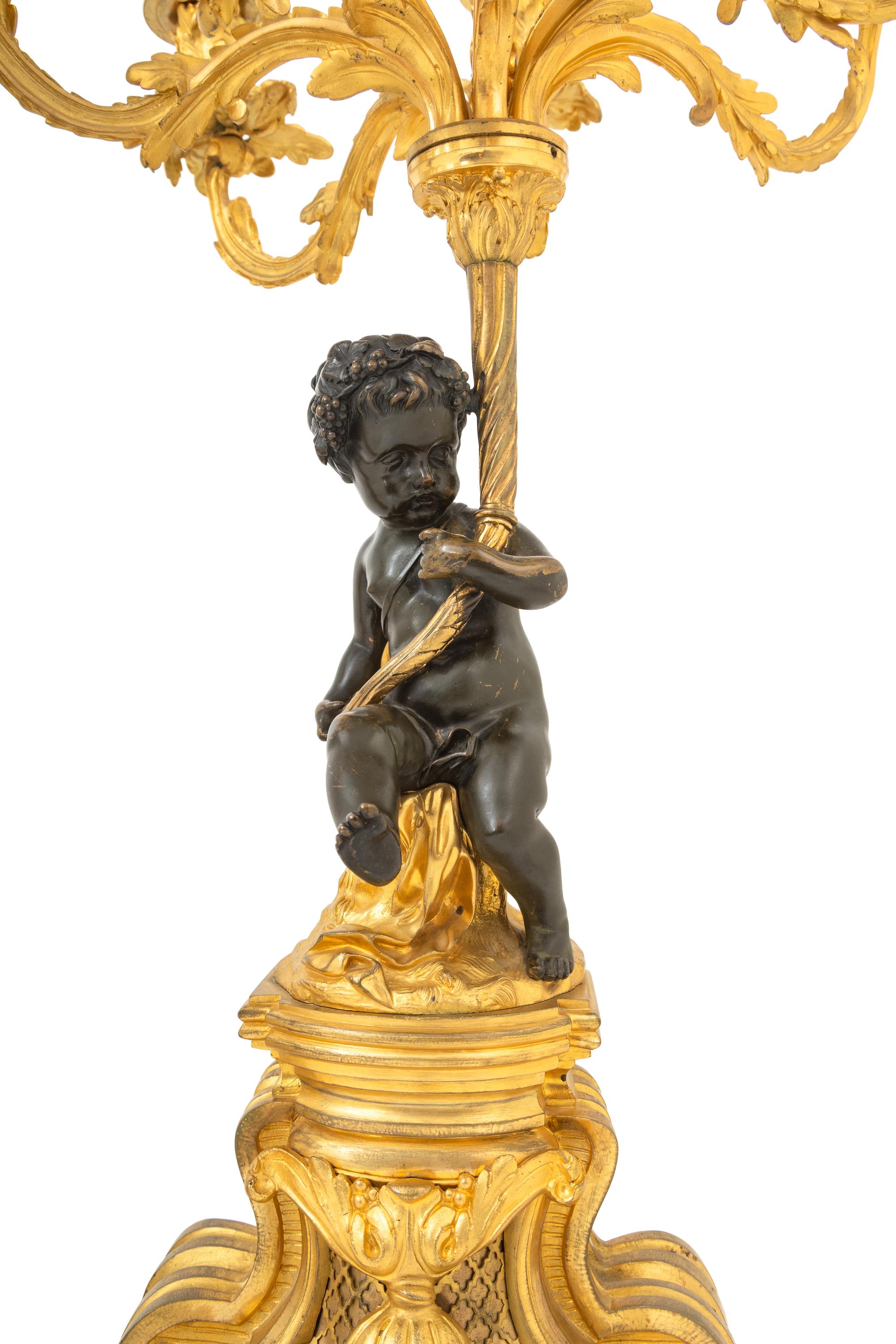 A Pair of French Gilt and Patinated Bronze Figural Seven-Light Candelabra