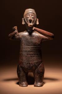 A Colima Terracotta Standing Male Figure with Incised Decoration